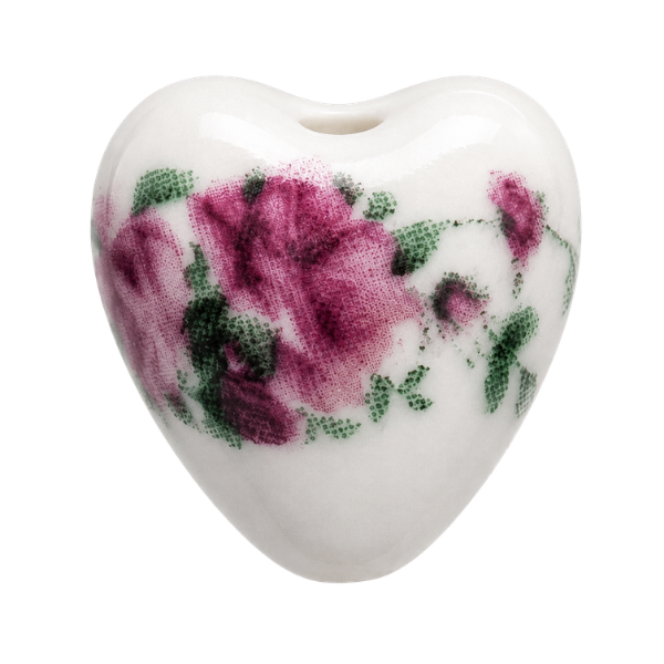 Heart-shaped ceramic charm with floral design on a white background